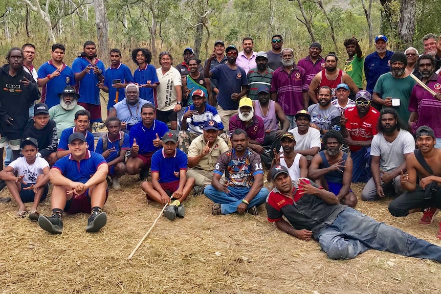 Large group of Indigenous men posing for a photo