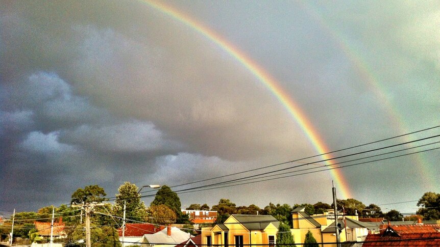 A double-rainbow forms over Melbourne.