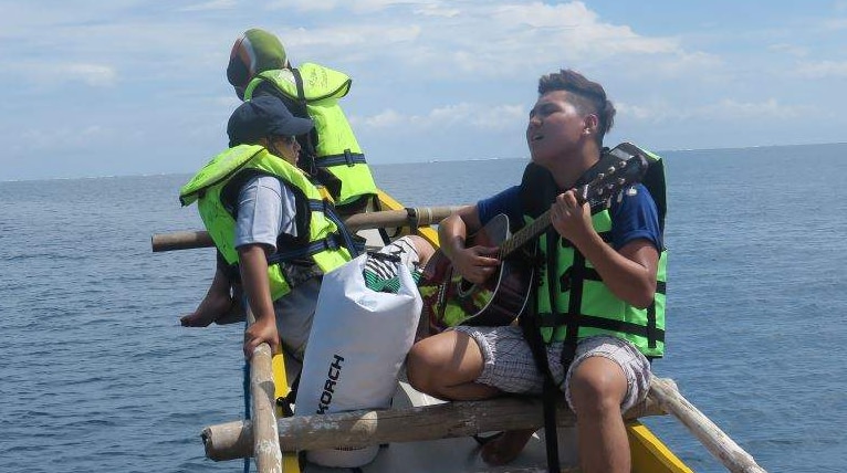 Kalayaan activist plays guitar aboard vessel