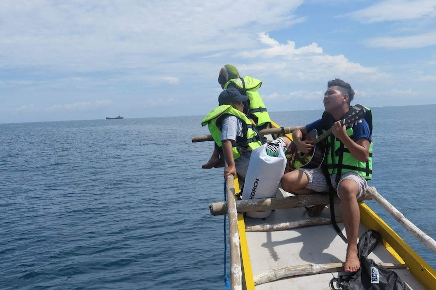 Kalayaan activist plays guitar aboard vessel