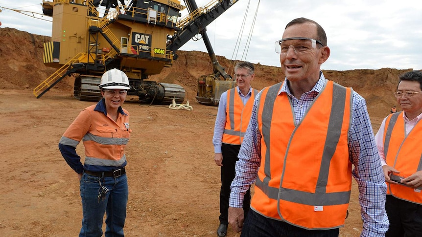 Prime Minister Tony Abbott leaves a demonstration at the opening of the Caval Ridge coal mine near Moranbah in central Qld