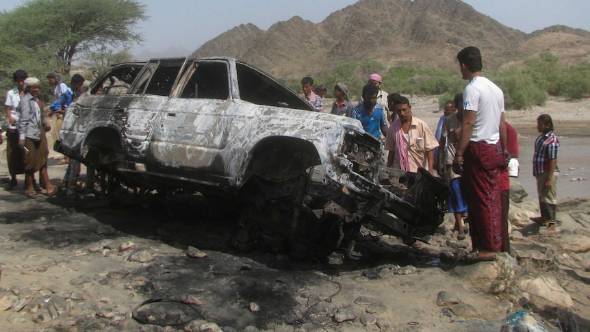People gather at the site of a drone strike in Yemen on August 11, 2013.