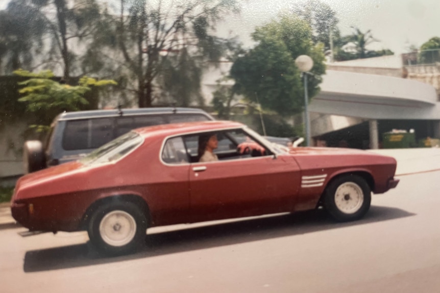 a maroon holden monaro from the 1990s.