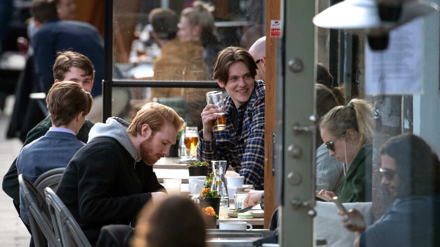 People enjoy themselves at an outdoor restaurant, amid the coronavirus outbreak in Stockholm.
