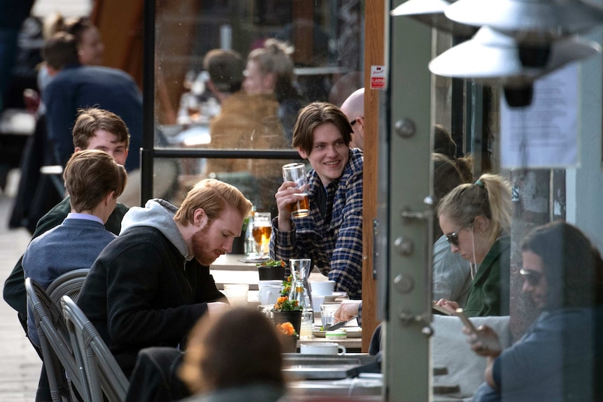 People enjoy themselves at an outdoor restaurant, amid the coronavirus outbreak in Stockholm.