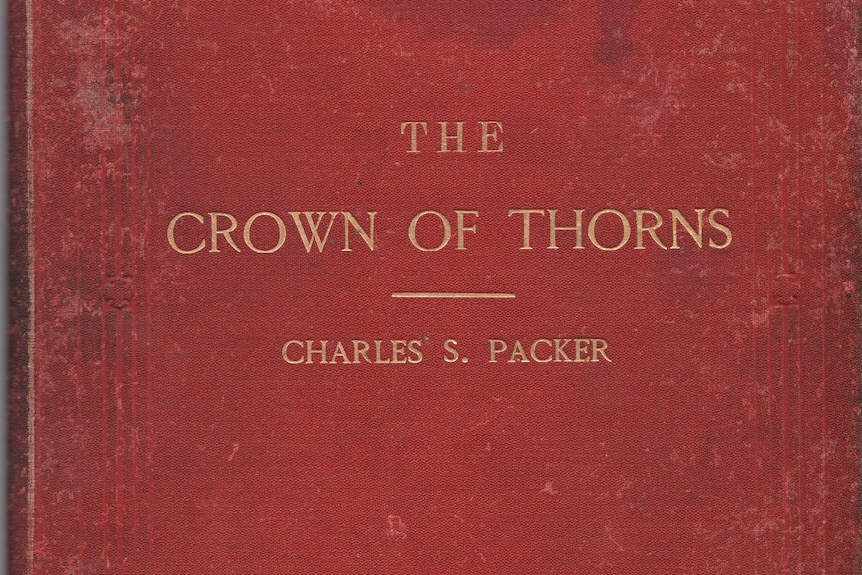 An old red book cover is printed in gold coloured text