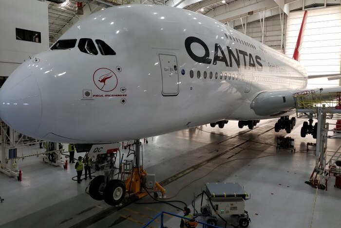 A Qantas A380 plane is seen parked in a hangar
