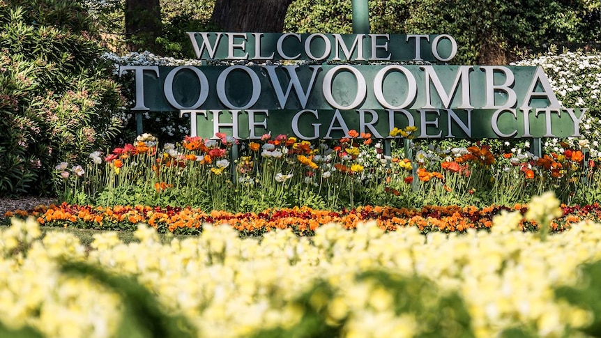 Welcome to Toowoomba sign surrounded by flowers
