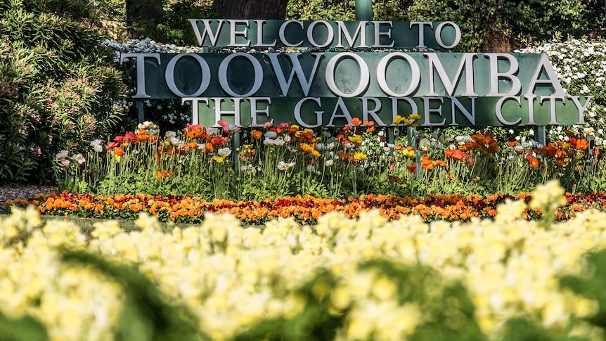 Welcome to Toowoomba sign surrounded by flowers