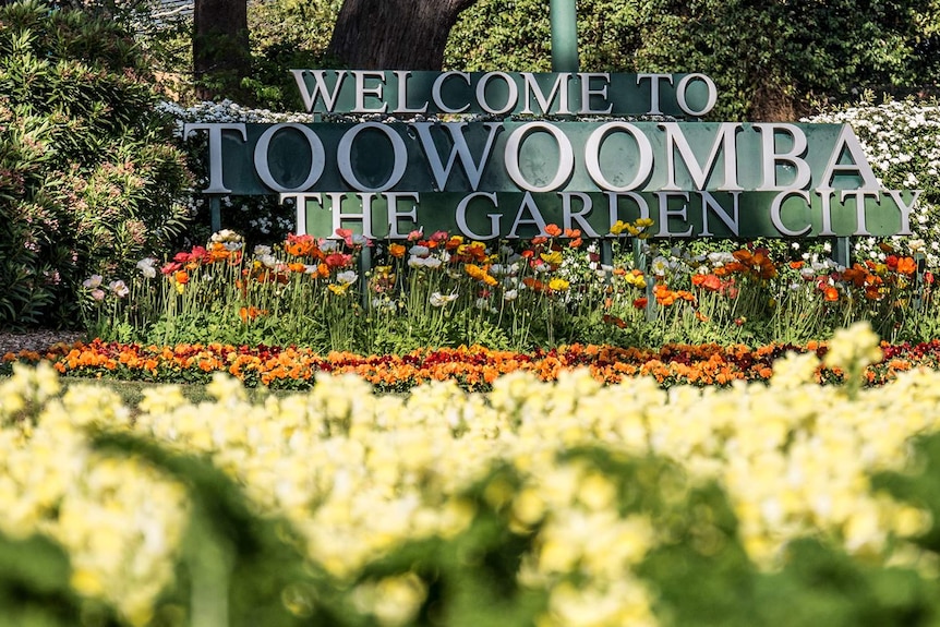 Welcome to Toowoomba sign surrounded by flowers