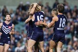 Fremantle players celebrate a goal against Essendon at Subiaco Oval on June 4, 2016.