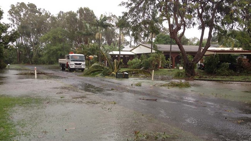 Fallen trees and floodwaters near a property at Kinka Beach