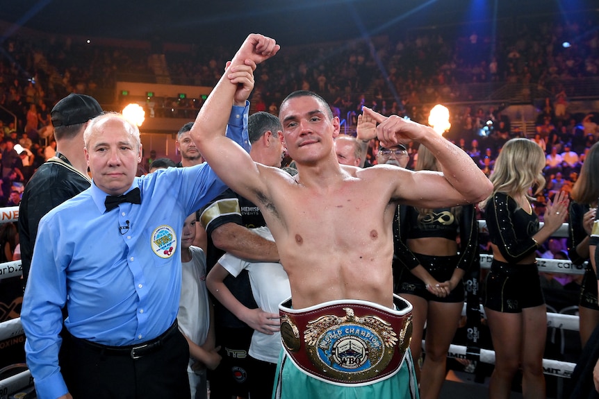 A man celebrates winning a boxing match