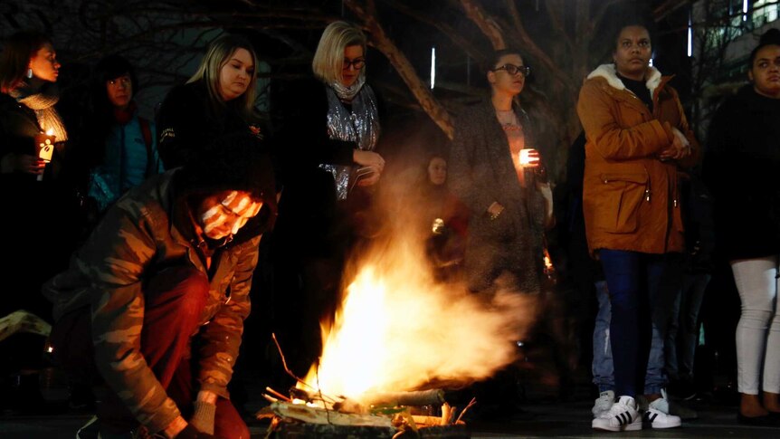 Protestors stand around a fire in Canberra.