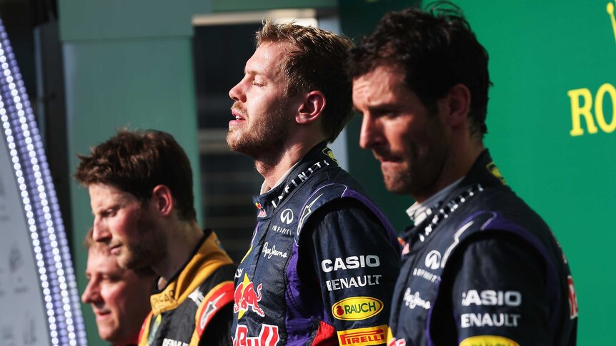 Historic result ... Sebastian Vettel (C) stands on the podium next to Mark Webber