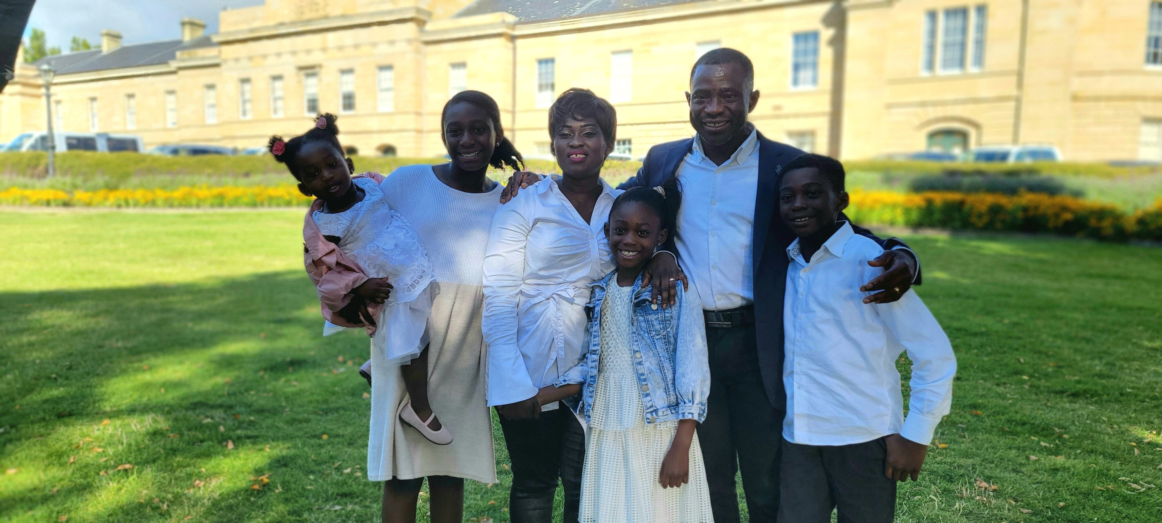 A man and his family smile for the camera
