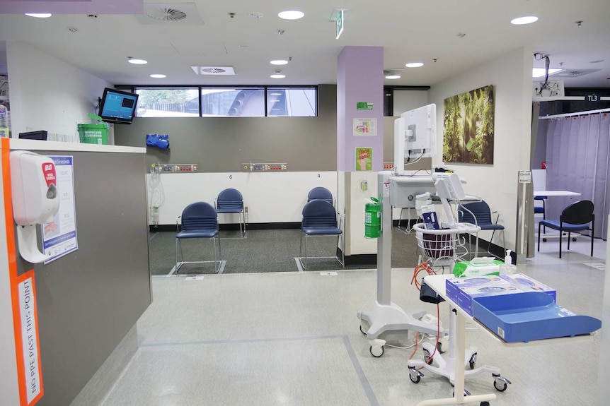 A large waiting room in a hospital, with chairs well spaced apart