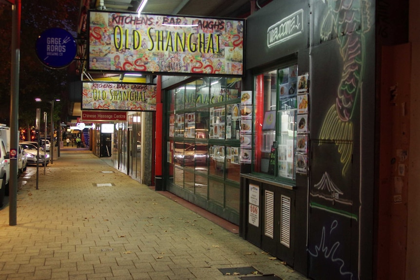 A closed shopfront on a deserted inner-city street