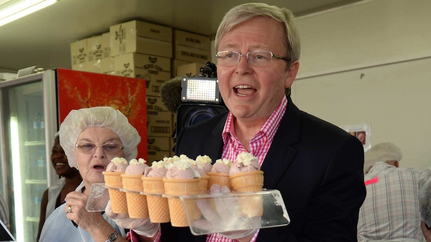 Kevin Rudd tries his hand selling strawberry sundaes during a visit to the Ekka