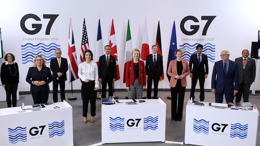 G7 foreign ministers stand for group photo.