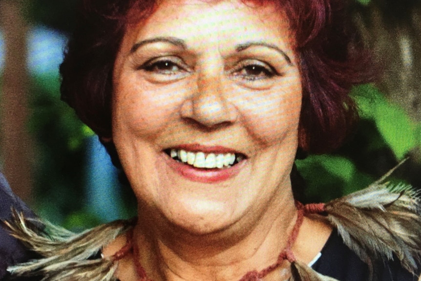 a lady with reddish hair smiles at the camera