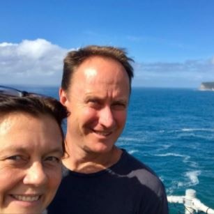 Tim Stewart and Lynelle Stewart in front of the ocean. 