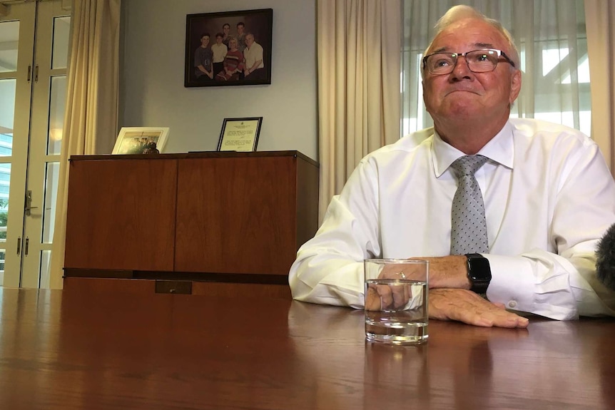 Gary Higgins sits behind his desk.