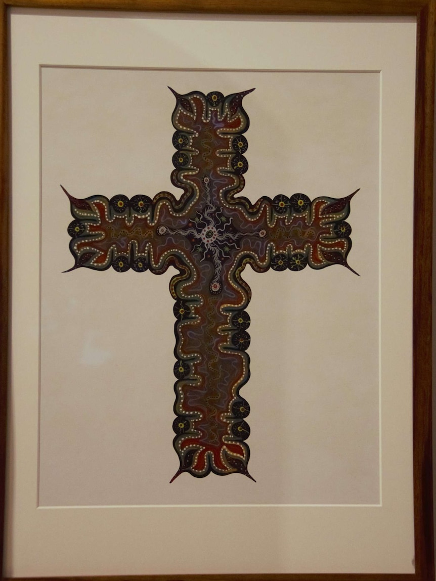 The crucifix incorporates a detailed traditional Australian indigenous form of art.