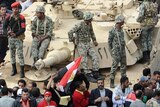 Protests continue: Egyptians pray in front of an Abrams tank in Cairo