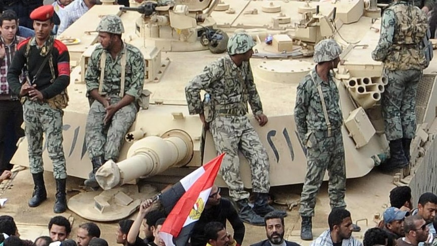 Protests continue: Egyptians pray in front of an Abrams tank in Cairo