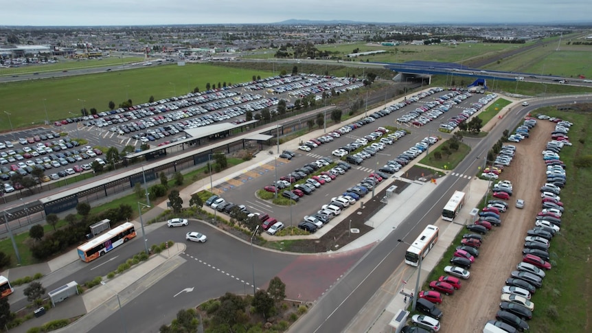 A car park overflowing with vehicles at a train station