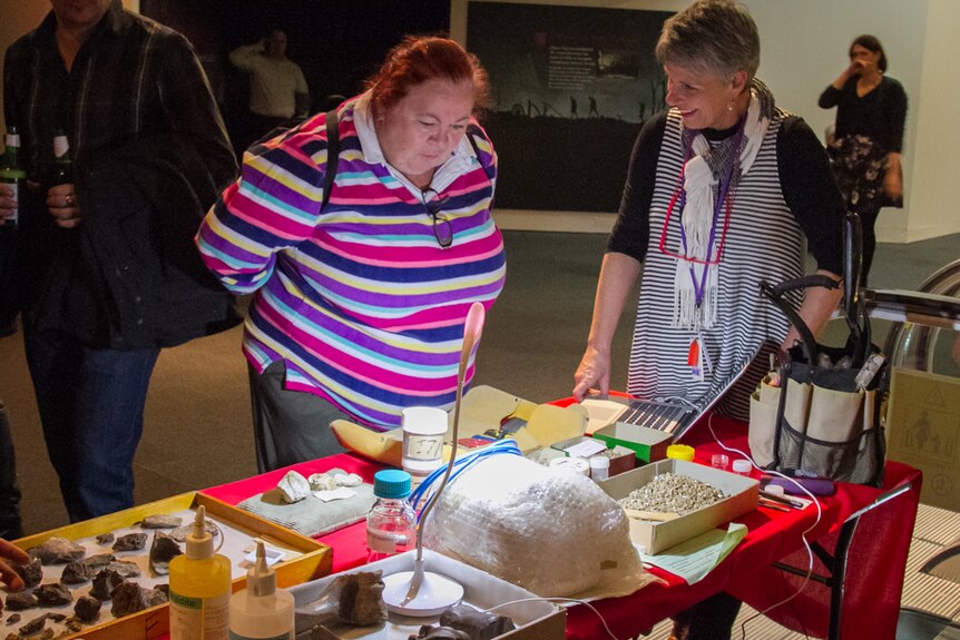 Dinosaur fans learn how to preserve fossils at one of the workshops at the Queensland Museum.