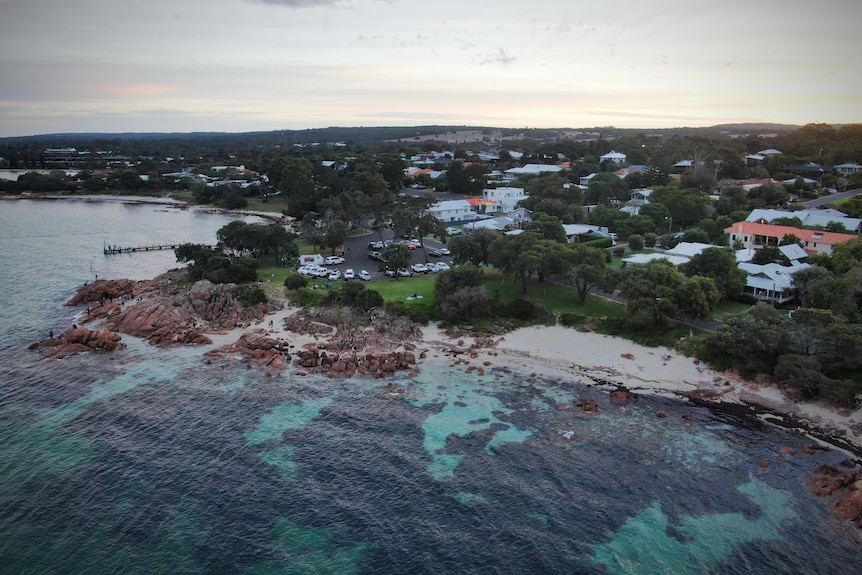 A drone shot of a seaside town at dusk