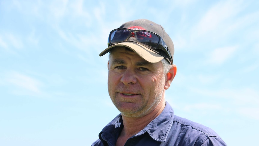 Dairy farmer Dale Hanks wearing a cap and sunglasses.