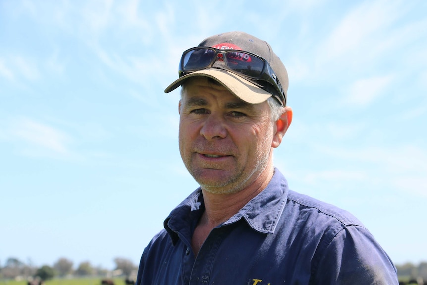 Dairy farmer Dale Hanks wearing a cap and sunglasses.