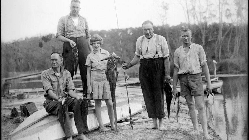 Four men and a girl displaying their fishing catch at Lake Conjola.