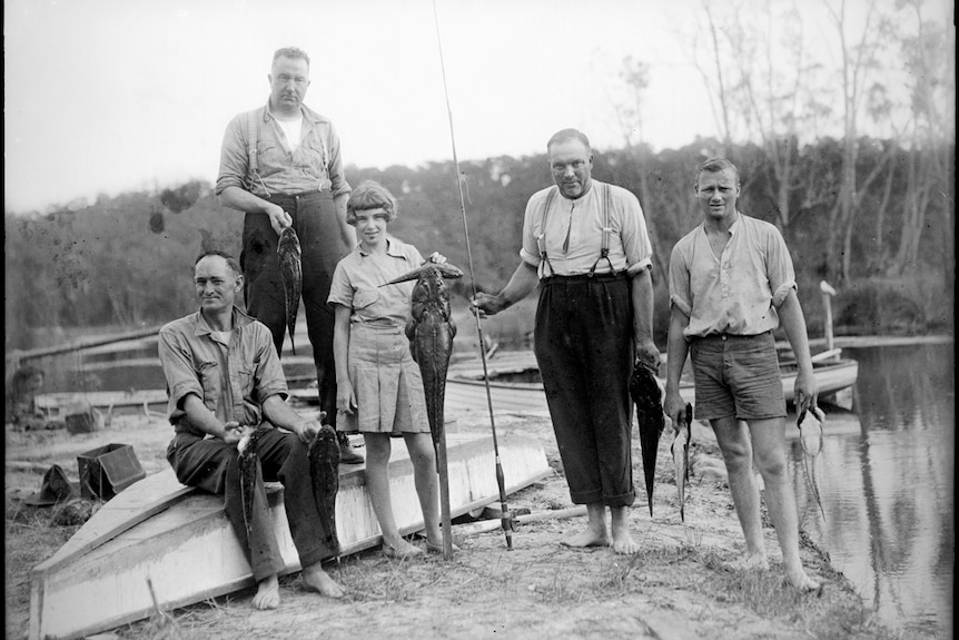 Four men and a girl displaying their fishing catch at Lake Conjola.