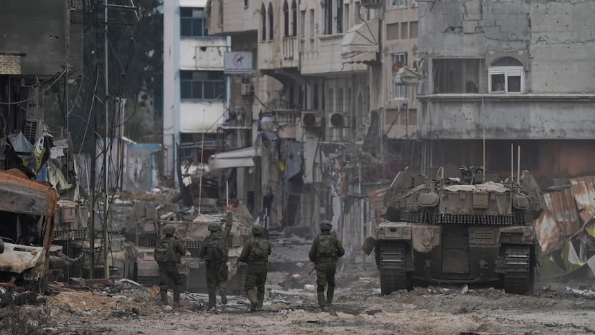 Soldiers and tanks seen on streets littered with rubble and debris