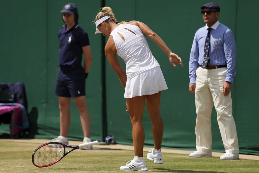 Angelique Kerber throws her racquet to the Wimbledon ground in disgust.