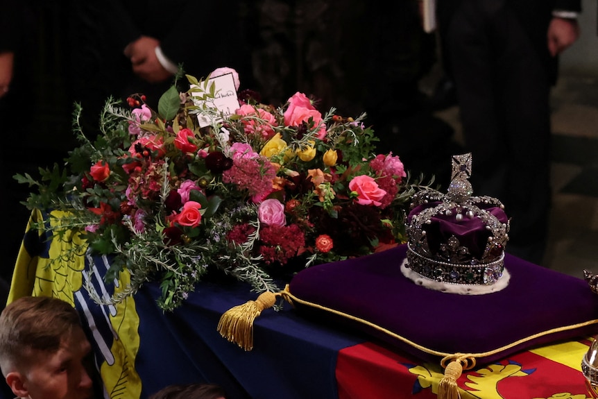 The Queen's coffin with crown and wreath on top. 