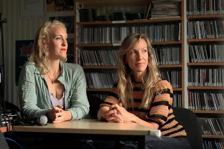 Two women in a radio studio. 