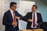 WA Treasurer Ben Wyatt and Premier Mark McGowan give each other an elbow bump