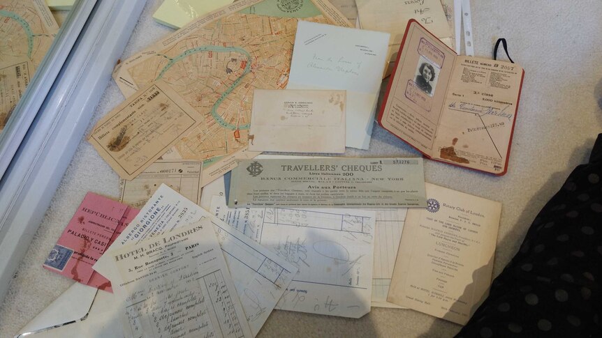 Old maps, souvenir tickets and Constance Stokes' passport on a table.