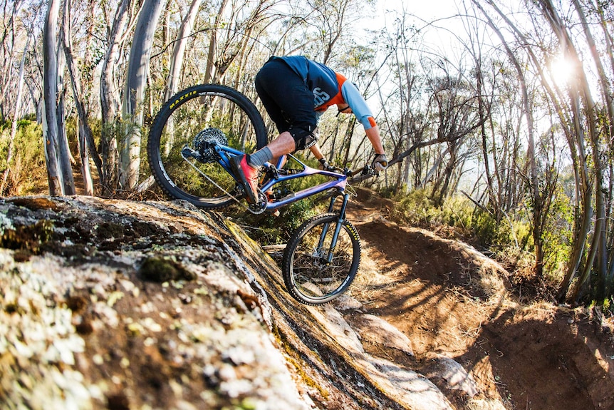 Mountain biker riding on an intense track.