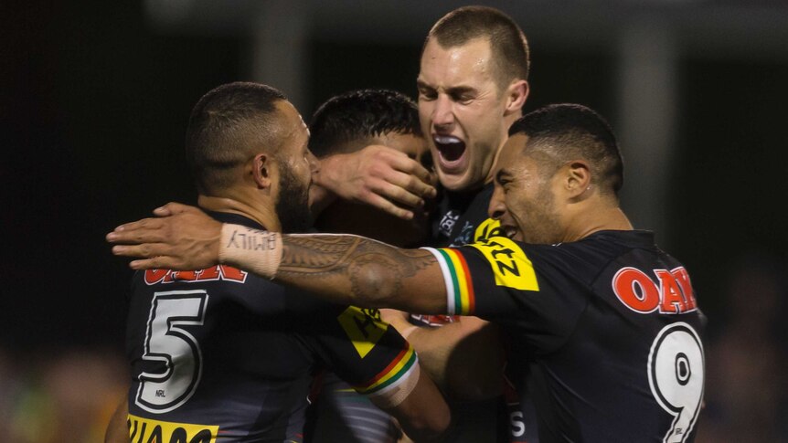 Tyrone Peachey celebrates a try with his Penrith Panthers teammates.