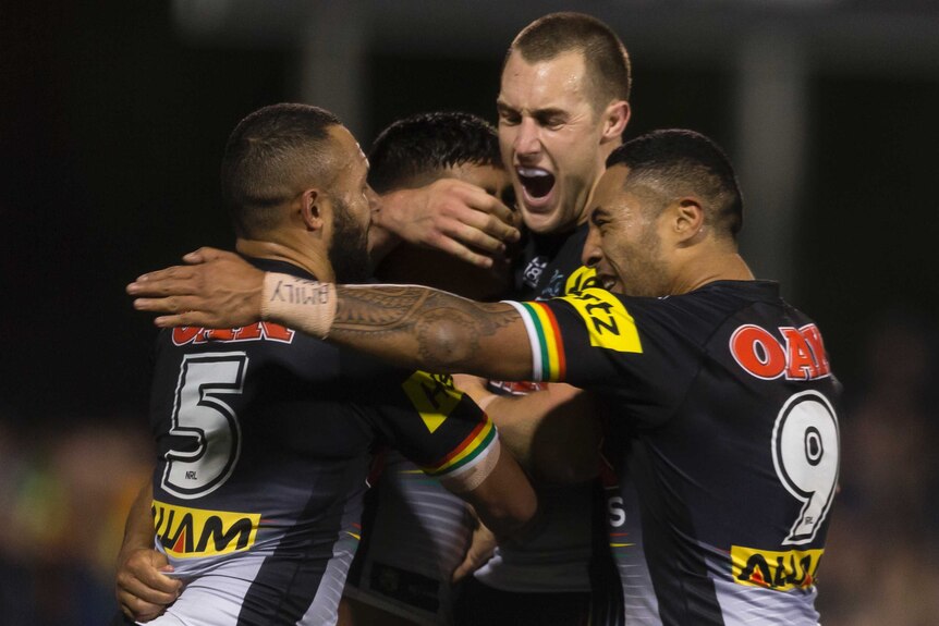 Tyrone Peachey celebrates a try with his Penrith Panthers teammates.
