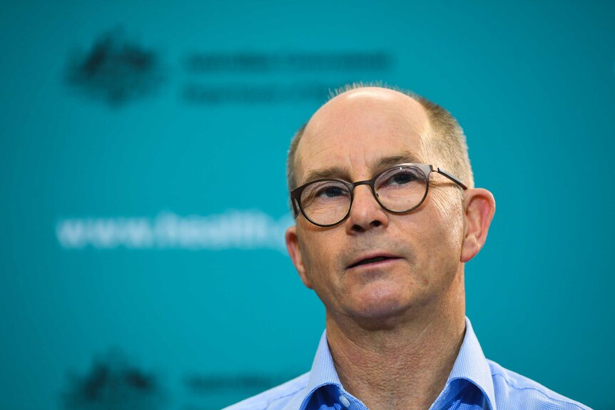 Professor Paul Kelly mid-speech at a media conference.