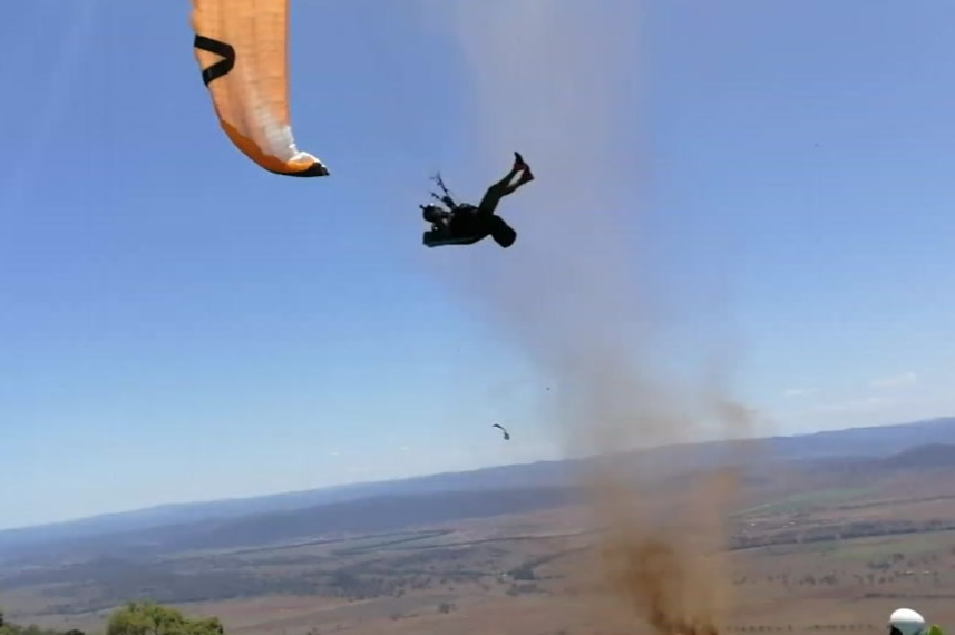 A paraglider drifts towards a dust devil in Manilla, near Tamworth, NSW.