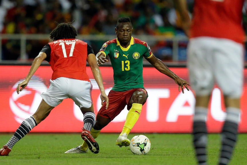 Cameroon's Christian Bassogog gets past Egypt's Mohamed Elneny