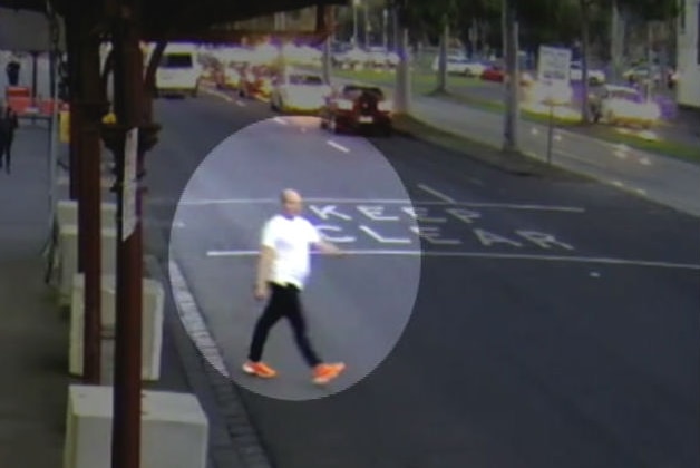 An highlighted image of a man walking across a Melbourne street.